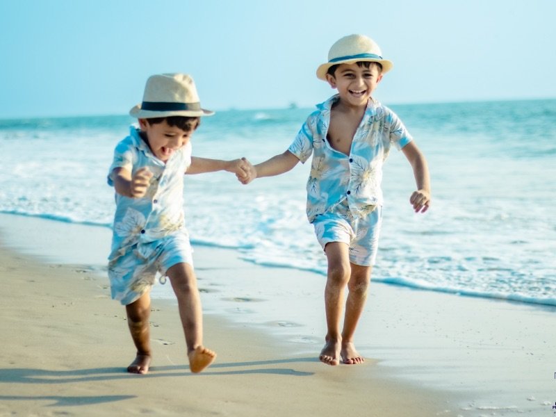 twins walking on the goan beach captured in camera by impression photography